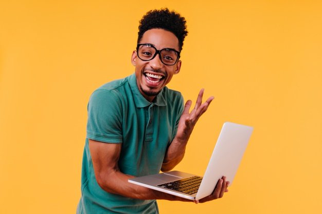 handsome male freelancer glasses smiling ecstatic african student holding laptop expressing happiness 197531 20166